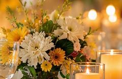 Candles, glassware and fresh flowers on an event table