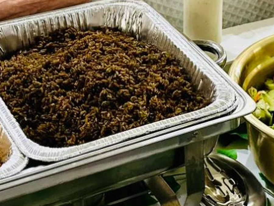 A chafing pan of Riz Djon Djon, Haitian black mushroom rice