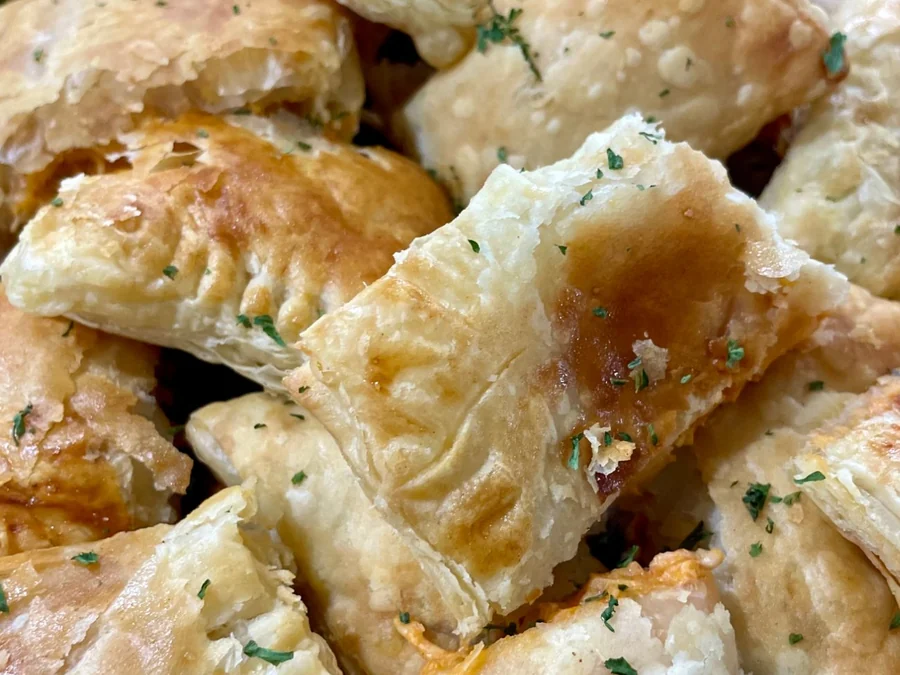 Golden puff-pastry mini patties on a wooden board