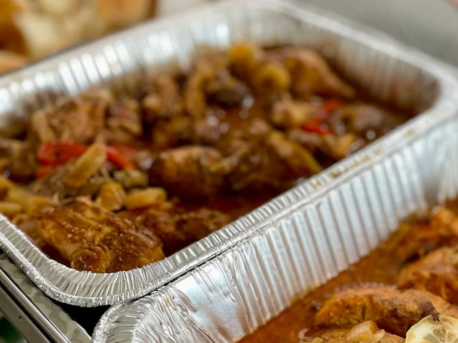 A pan of Haitian chicken braised with peppers and onions