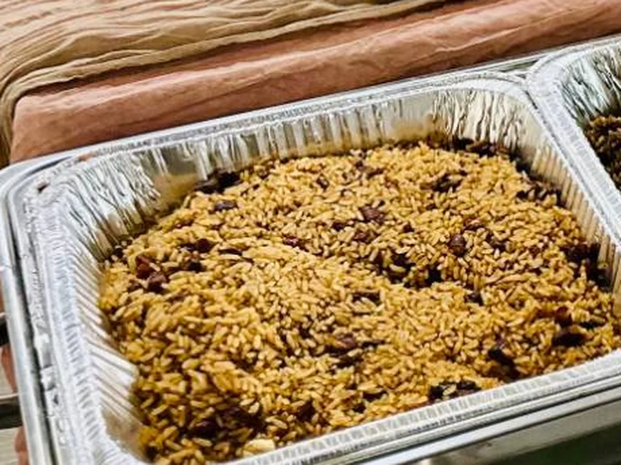A chafing pan of Haitian rice and beans