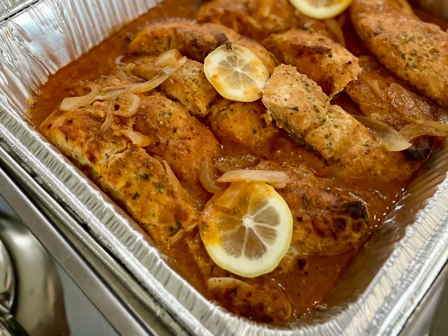 A pan of Creole salmon with lemon and onions